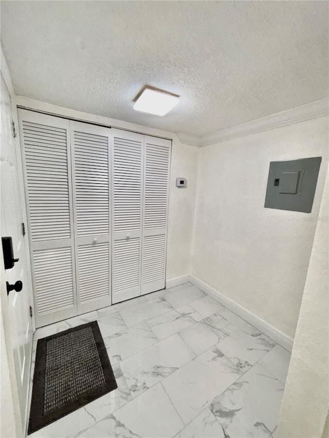 interior space featuring ornamental molding, hookup for an electric dryer, electric panel, and a textured ceiling