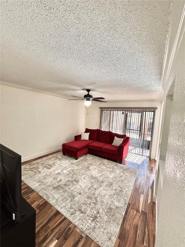 living room with wood-type flooring, ornamental molding, ceiling fan, and a textured ceiling