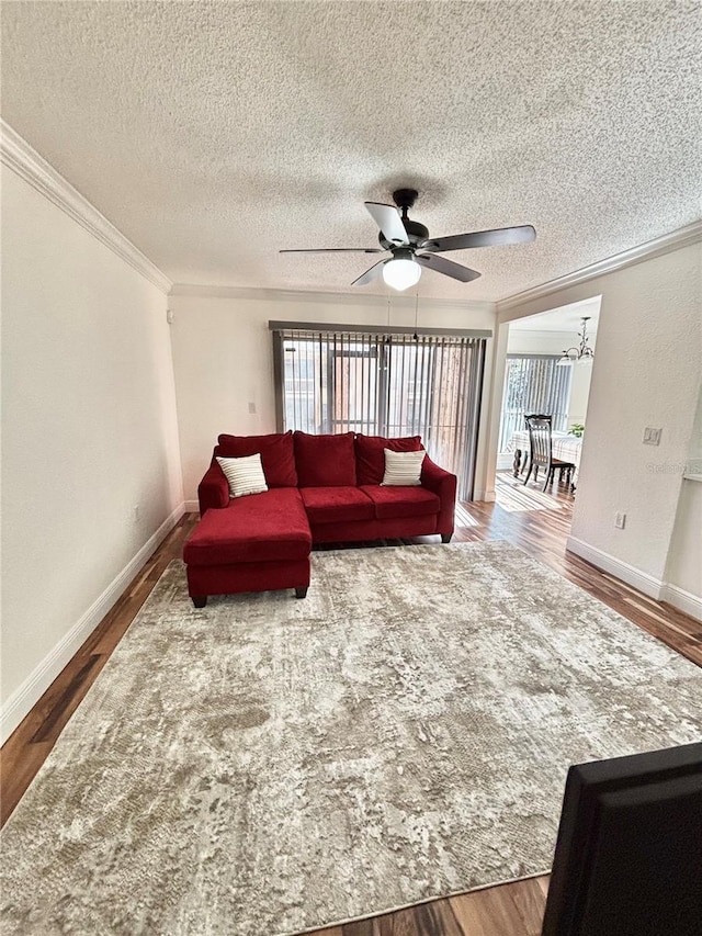 living room with crown molding, hardwood / wood-style floors, ceiling fan, and a textured ceiling