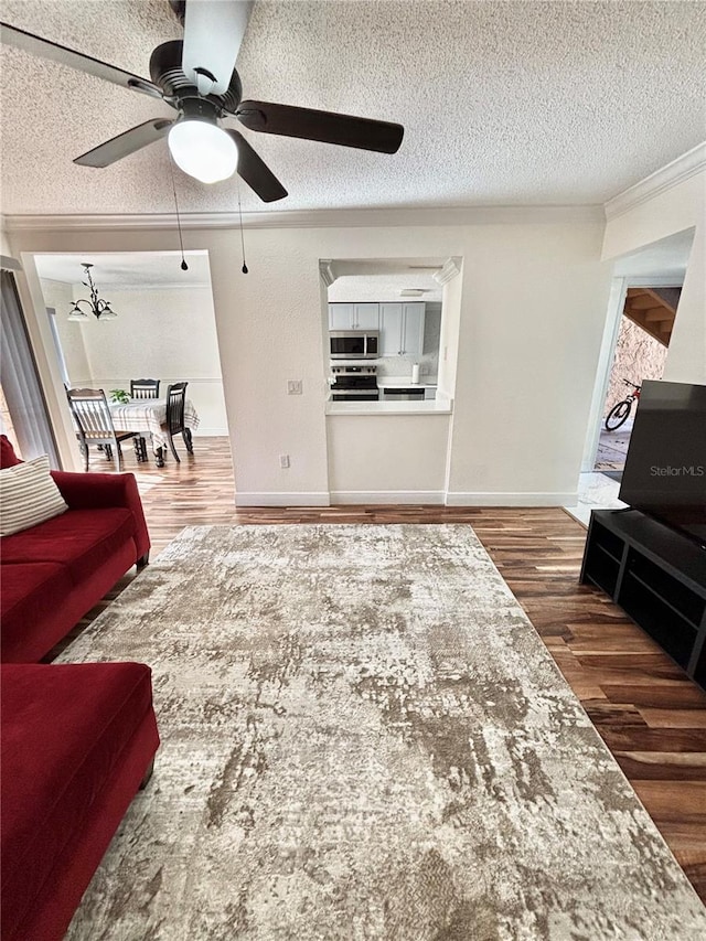 living room featuring crown molding, dark hardwood / wood-style floors, and a textured ceiling