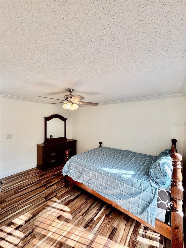 bedroom with crown molding, dark hardwood / wood-style floors, a textured ceiling, and ceiling fan