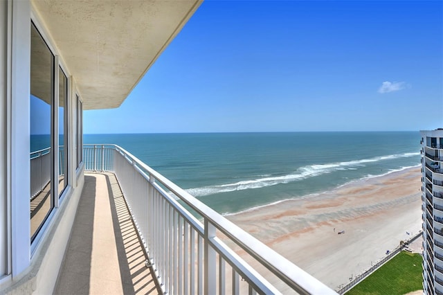 balcony with a beach view and a water view