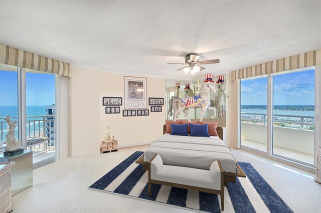 bedroom with a water view, ceiling fan, and access to exterior