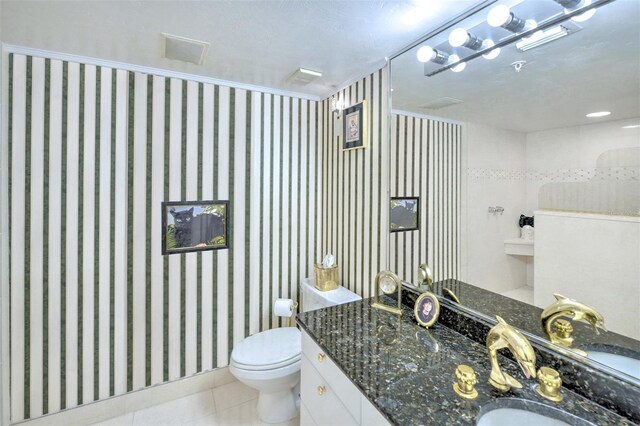 bathroom featuring tile flooring, toilet, and large vanity