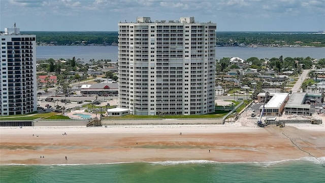 birds eye view of property with a view of the beach and a water view