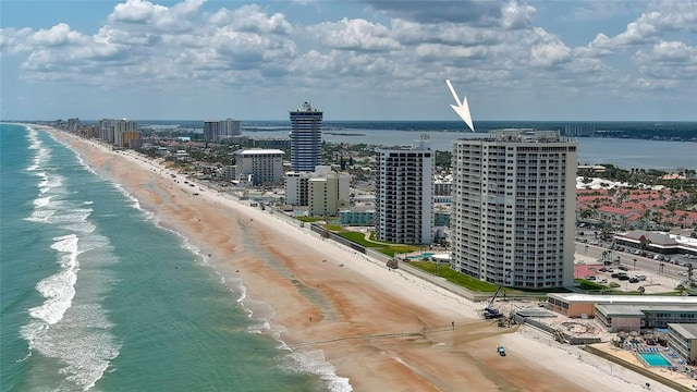 drone / aerial view featuring a beach view and a water view