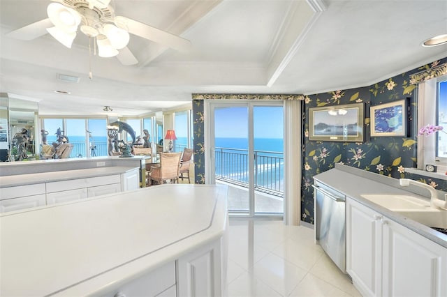 kitchen featuring a water view, dishwasher, ceiling fan, white cabinets, and light tile floors