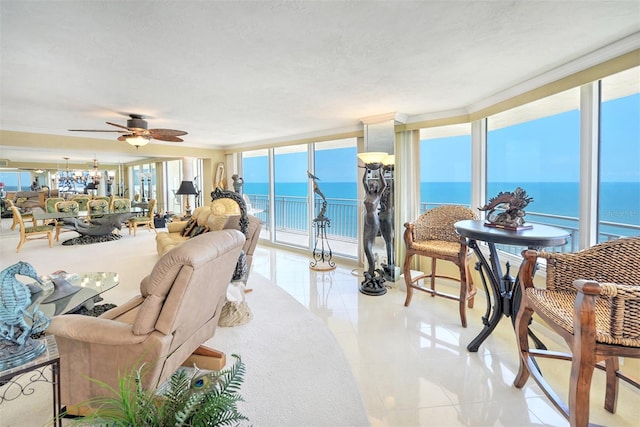 living room with a water view, ceiling fan, floor to ceiling windows, light tile floors, and a textured ceiling