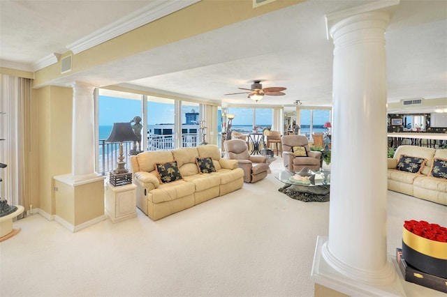 living room featuring carpet flooring, ornate columns, ornamental molding, and ceiling fan