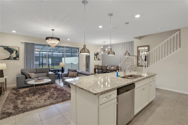 kitchen with white cabinetry, a center island with sink, stainless steel dishwasher, sink, and light tile floors