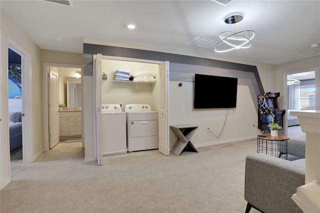 carpeted living room with washing machine and clothes dryer