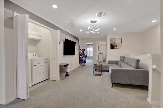 carpeted living room featuring washer / clothes dryer