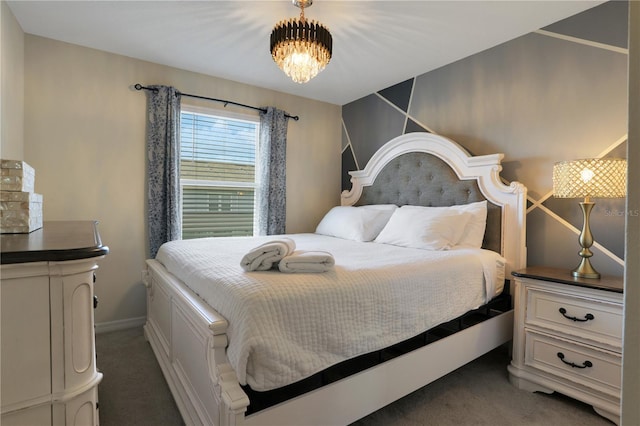 bedroom with dark colored carpet and an inviting chandelier