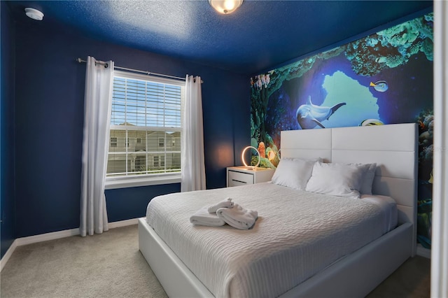 bedroom featuring a textured ceiling and carpet flooring