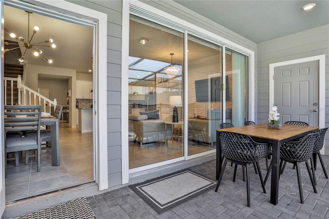 sunroom featuring a chandelier