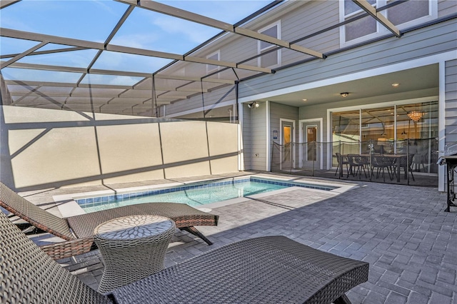 view of pool with a patio and a lanai