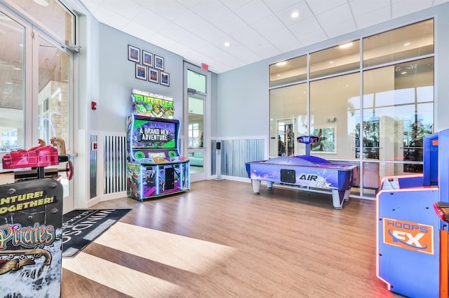 rec room with a towering ceiling, wood-type flooring, and pool table