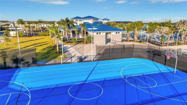 view of basketball court with a lawn