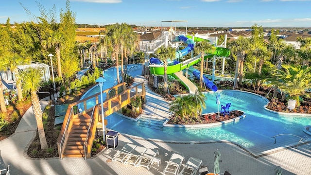 view of pool with a water slide and a patio