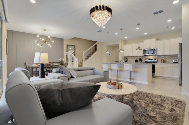 living room featuring a notable chandelier and light tile floors