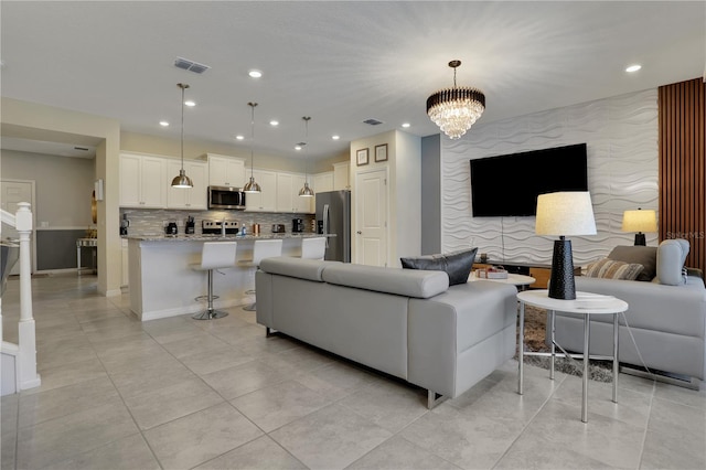 tiled living room featuring an inviting chandelier