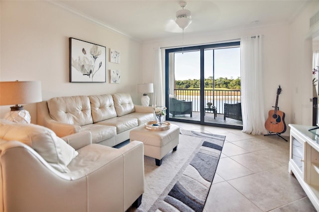 tiled living room with ceiling fan and ornamental molding