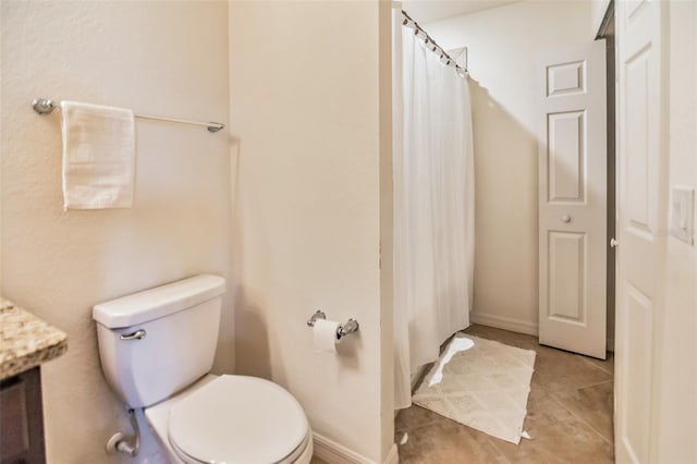 bathroom featuring tile patterned floors, curtained shower, vanity, and toilet