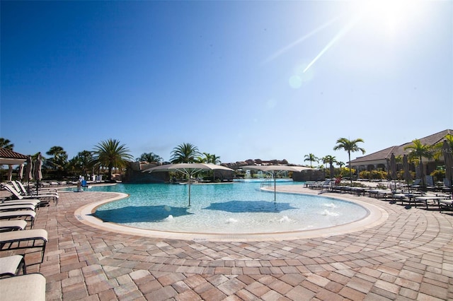 view of pool with pool water feature and a patio