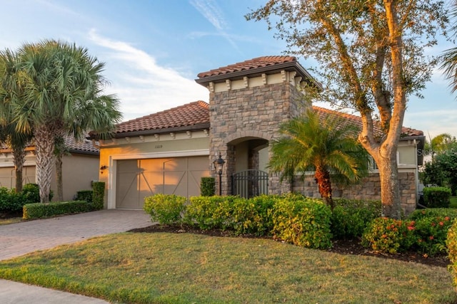 mediterranean / spanish-style house with a front lawn and a garage