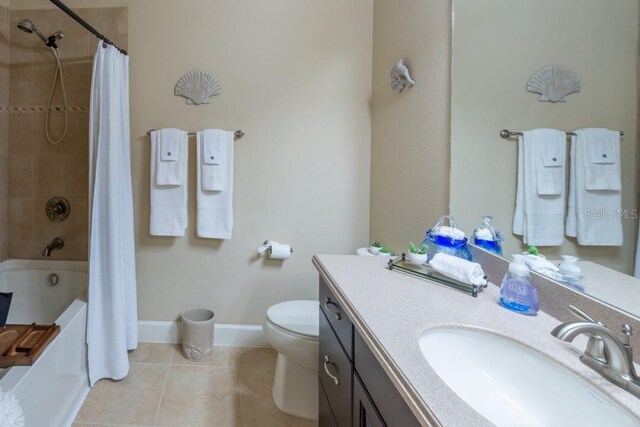 full bathroom with tile patterned floors, shower / bath combination with curtain, vanity, and toilet