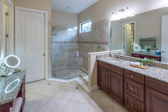 bathroom featuring an enclosed shower, vanity, and tile patterned floors