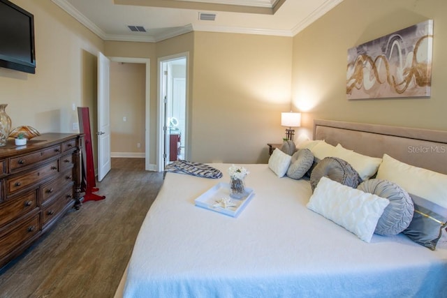 bedroom with ornamental molding and dark hardwood / wood-style floors