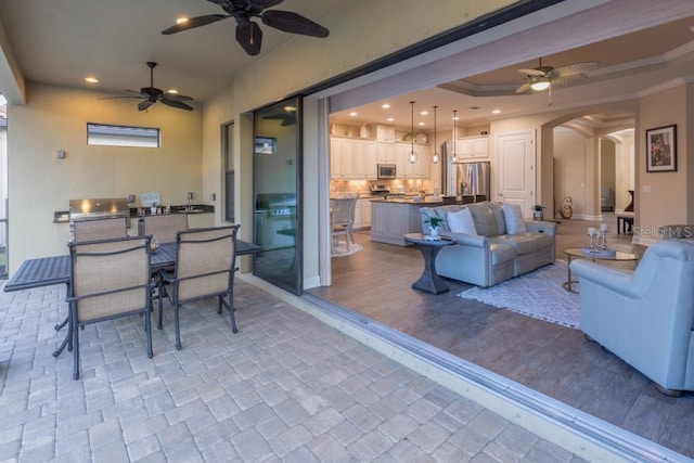 view of patio / terrace with an outdoor kitchen and ceiling fan