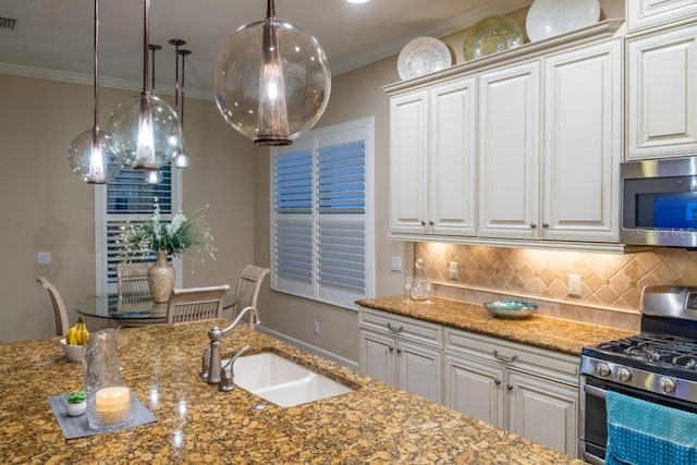 kitchen featuring sink, appliances with stainless steel finishes, decorative backsplash, crown molding, and white cabinets