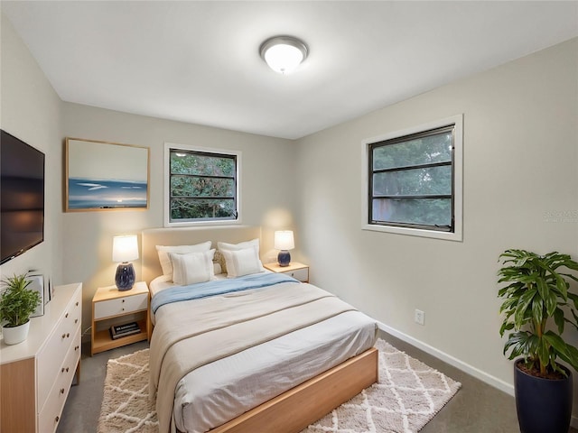 bedroom with dark colored carpet