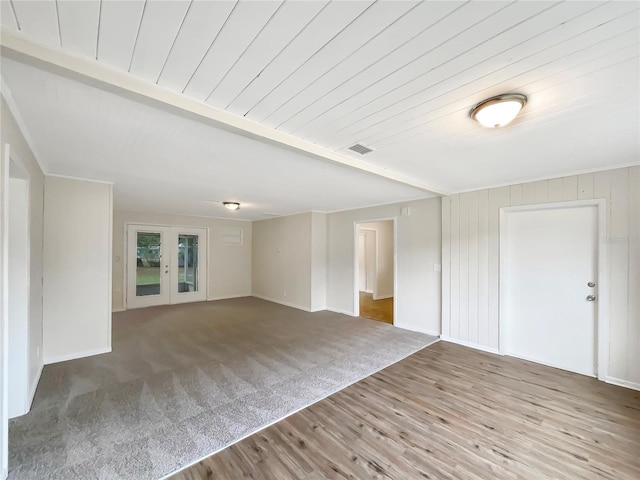 empty room featuring french doors and hardwood / wood-style floors