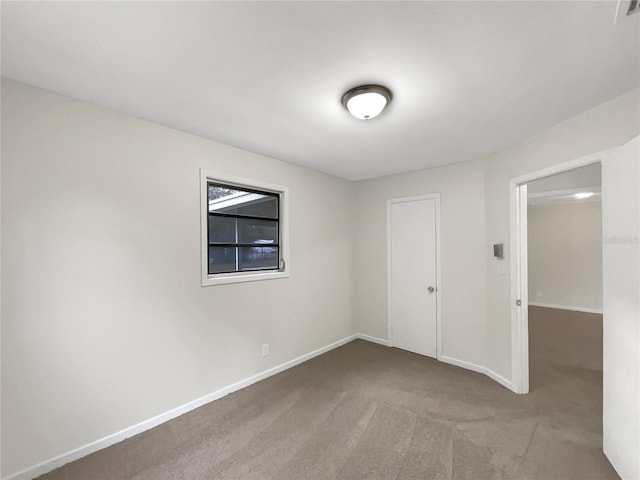 unfurnished room featuring light carpet