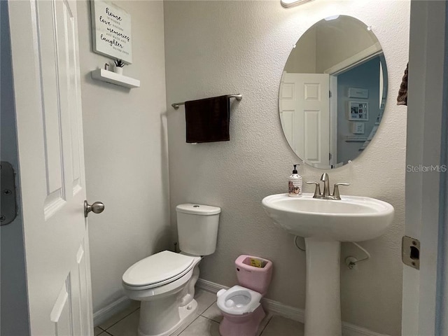 bathroom with tile patterned floors and toilet