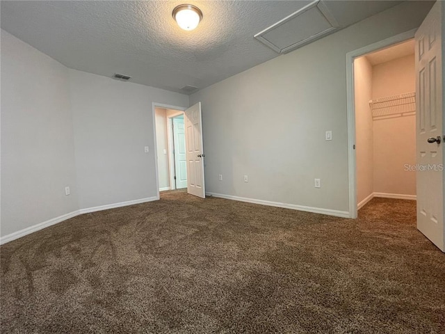 carpeted spare room with a textured ceiling