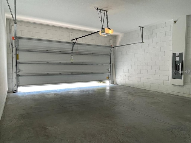 garage with a garage door opener and electric panel