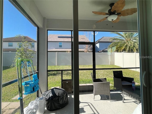 sunroom / solarium featuring ceiling fan