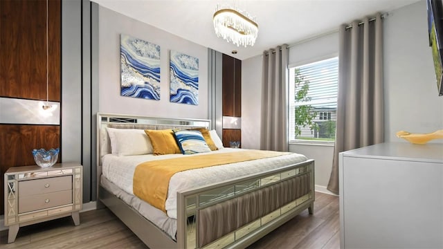 bedroom with an inviting chandelier and wood-type flooring