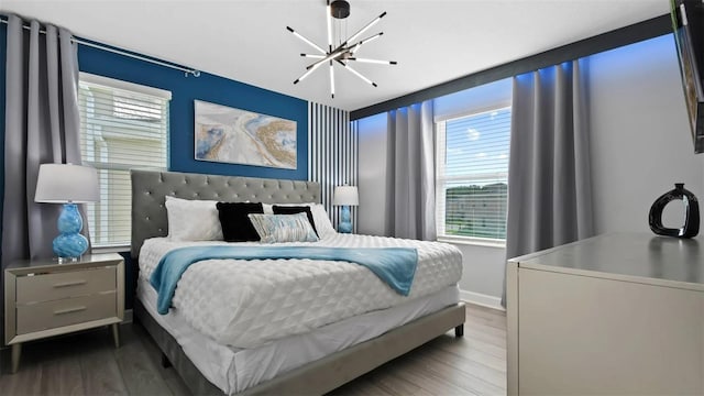 bedroom with a notable chandelier and hardwood / wood-style flooring