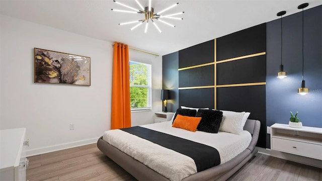 bedroom featuring an inviting chandelier and hardwood / wood-style floors