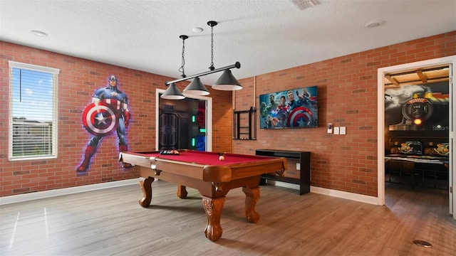 rec room with hardwood / wood-style flooring, brick wall, and pool table