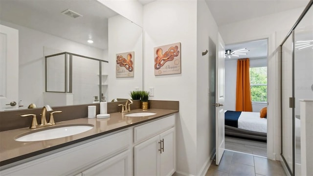 bathroom with dual bowl vanity, an enclosed shower, ceiling fan, and tile floors