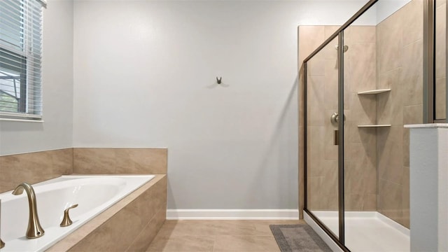 bathroom featuring tile flooring and separate shower and tub