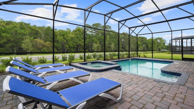 view of swimming pool with a lanai, an in ground hot tub, and a patio area