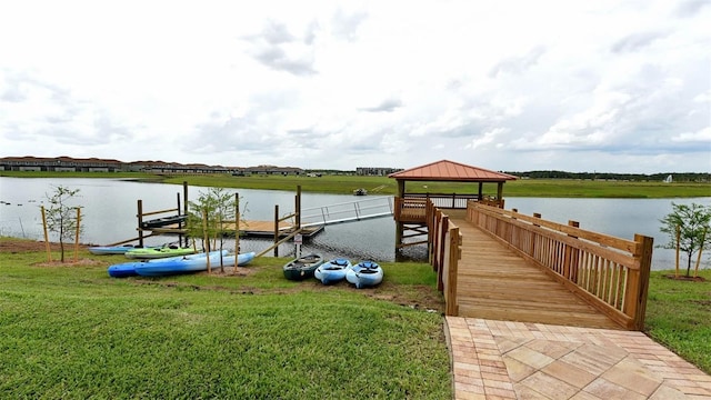 view of dock featuring a yard, a water view, and a gazebo