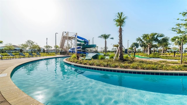 view of swimming pool with a water slide